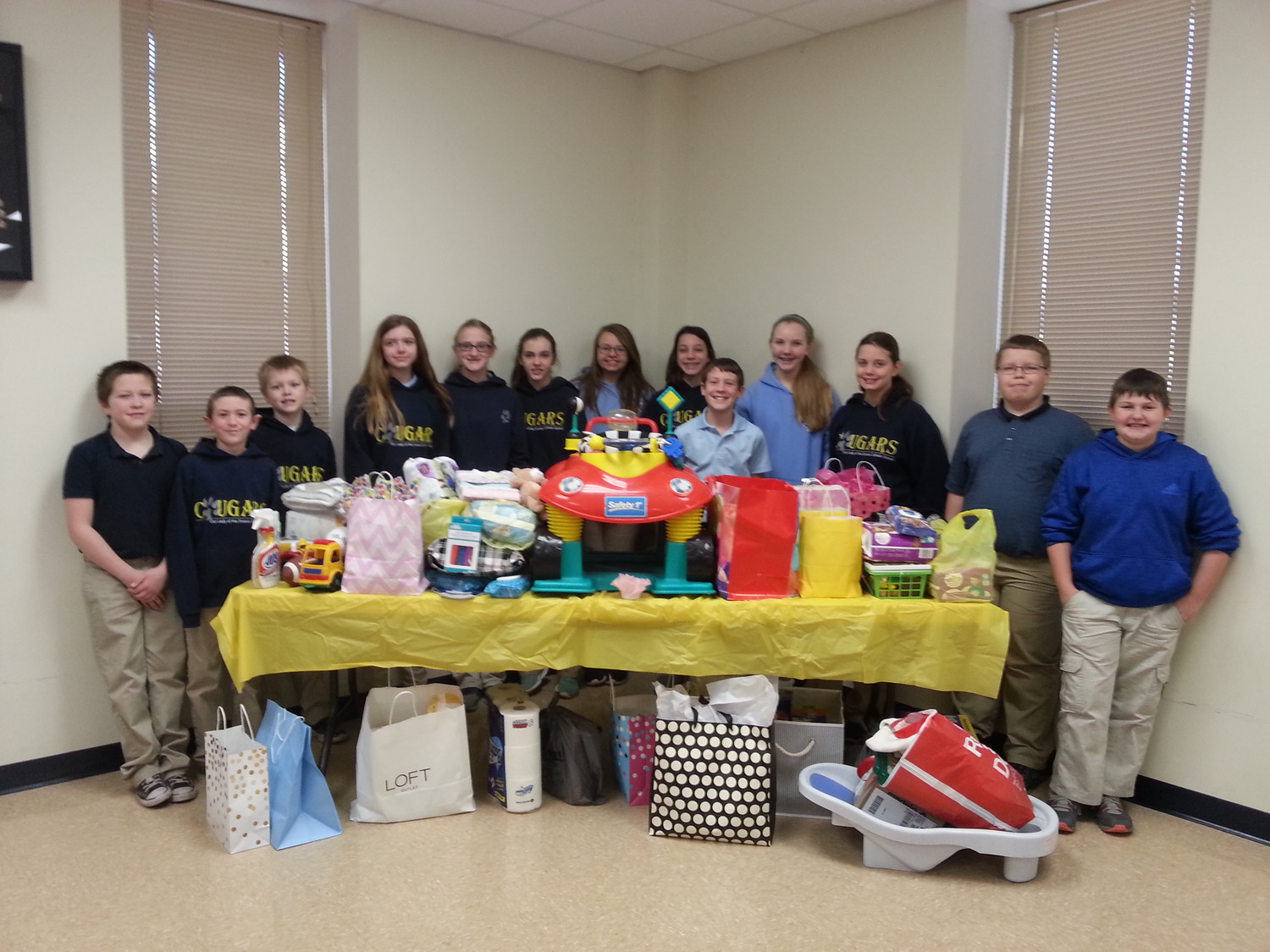Members of the student council of Our Lady of Lourdes Interparish School in Columbia display the gifts they received at a baby shower they organized for the St. Raymond’s Society, a comprehensive ministry for woman who are in crisis pregnancies, and their babies.